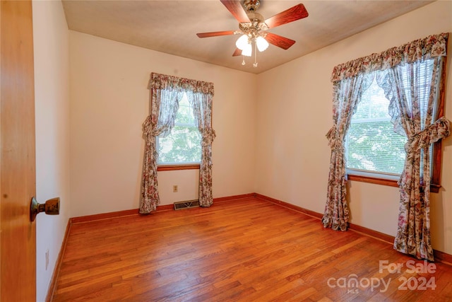 empty room featuring hardwood / wood-style floors and ceiling fan