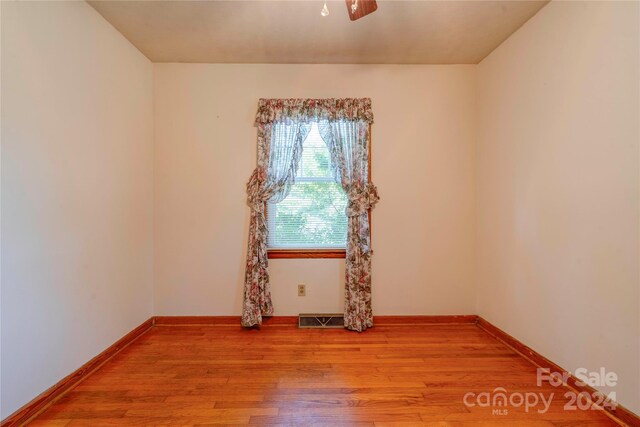 spare room featuring ceiling fan and light hardwood / wood-style floors