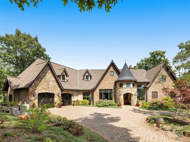 85 Smokey Ridge Trl, Arden, NC 28704 - view of front of house featuring stone siding, a chimney, decorative driveway, and stucco siding