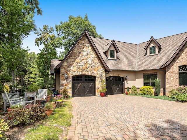 85 Smokey Ridge Trl, Arden, NC 28704 - view of front facade featuring stone siding, stucco siding, decorative driveway, and an attached garage