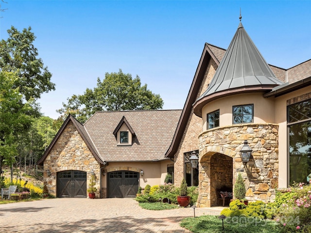 85 Smokey Ridge Trl, Arden, NC 28704 - view of front of house featuring stone siding, stucco siding, decorative driveway, a standing seam roof, and a garage