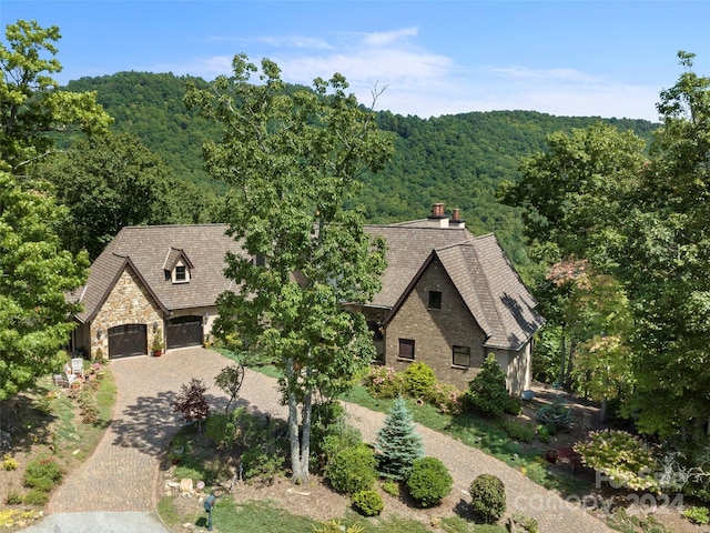 85 Smokey Ridge Trl, Arden, NC 28704 - tudor home with a view of trees, decorative driveway, stone siding, and a chimney