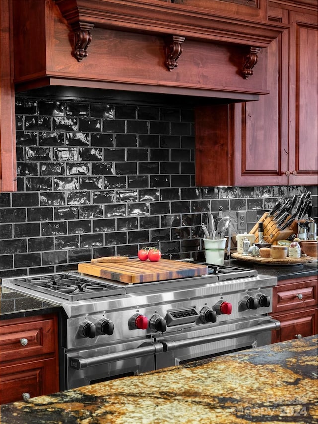 85 Smokey Ridge Trl, Arden, NC 28704 - kitchen featuring range with two ovens, tasteful backsplash, dark stone countertops, and dark brown cabinets