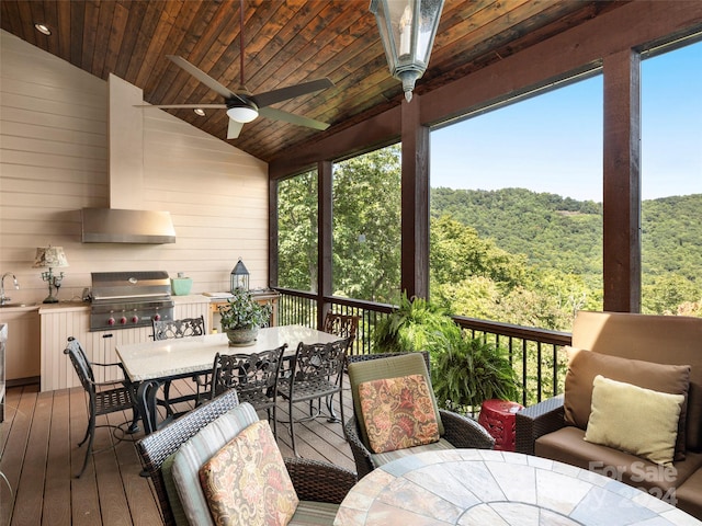 sunroom / solarium featuring wooden ceiling, vaulted ceiling, sink, and ceiling fan