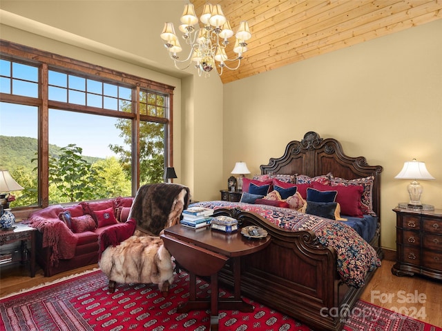 85 Smokey Ridge Trl, Arden, NC 28704 - bedroom with a chandelier, wood finished floors, and vaulted ceiling