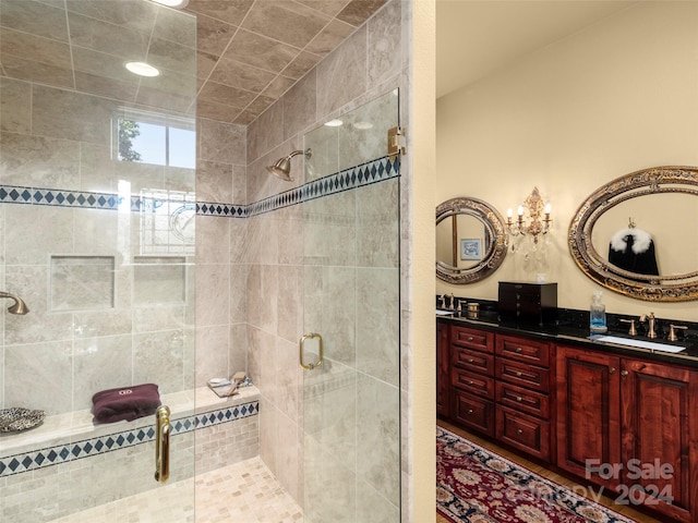 bathroom featuring vanity and a shower with shower door