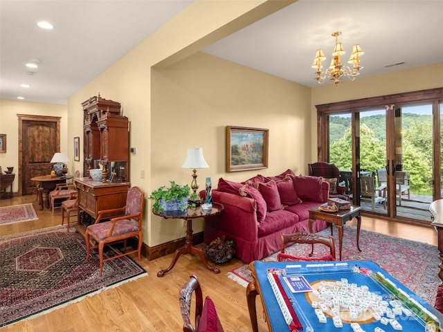 living room with a notable chandelier and hardwood / wood-style floors