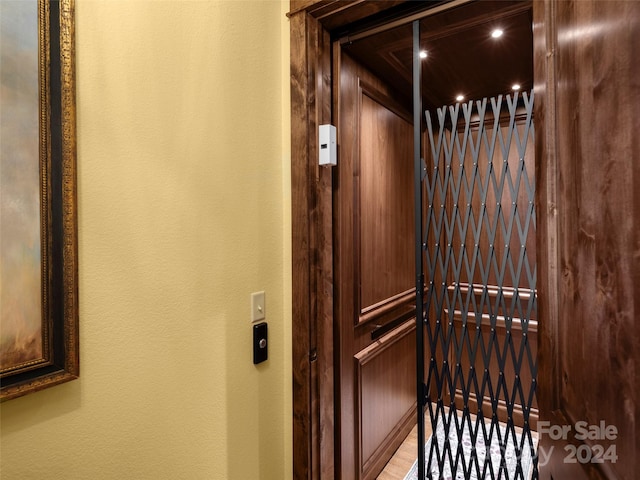 details with hardwood / wood-style floors and elevator