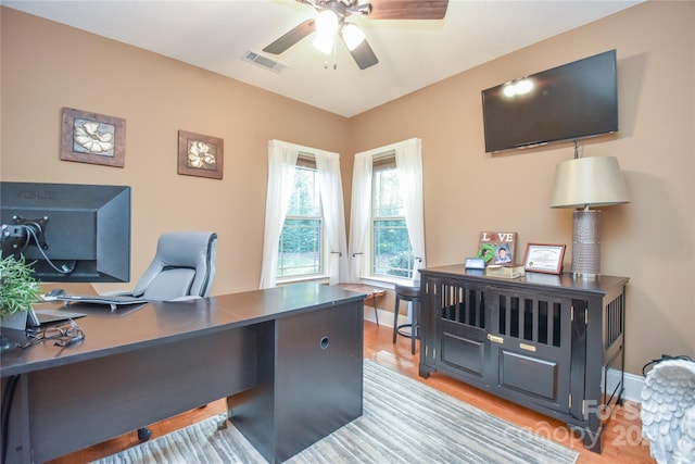 home office featuring light wood-type flooring and ceiling fan