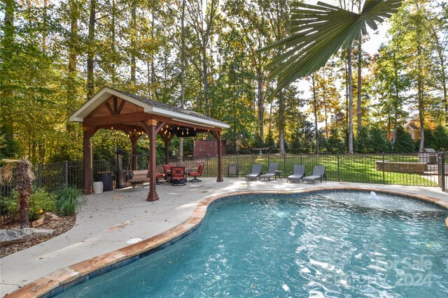 view of swimming pool with a gazebo and a patio area