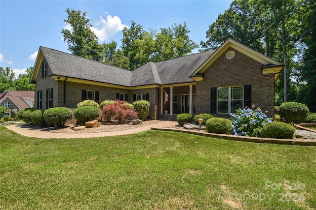 single story home featuring a front lawn