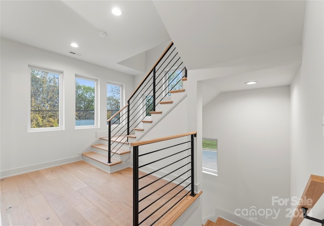 staircase with hardwood / wood-style flooring