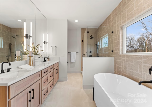 bathroom featuring vanity, separate shower and tub, and tile walls