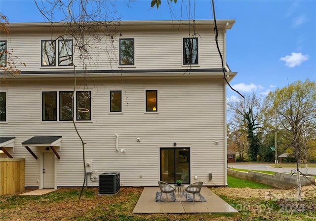 back of property with a patio area and central air condition unit