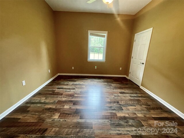 spare room featuring ceiling fan and dark hardwood / wood-style floors