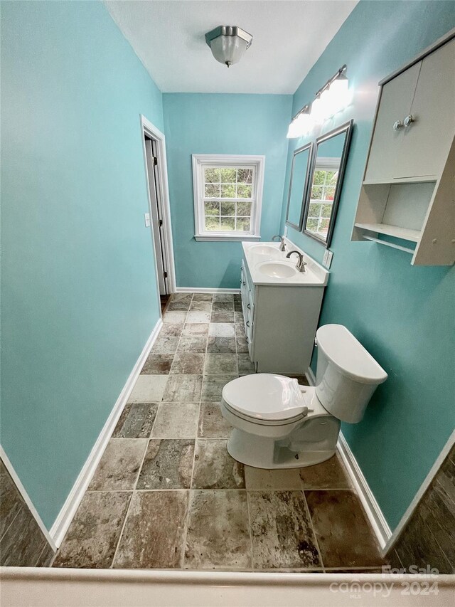 bathroom with toilet and vanity