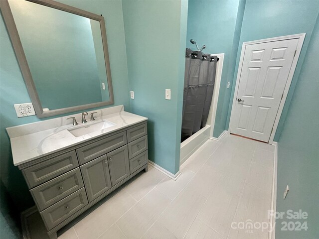 bathroom with vanity, shower / tub combo with curtain, and tile patterned floors