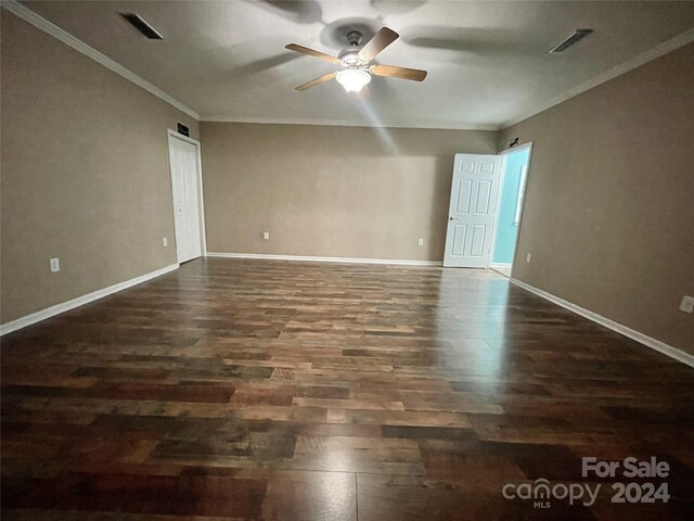 unfurnished room with crown molding, ceiling fan, and dark hardwood / wood-style floors