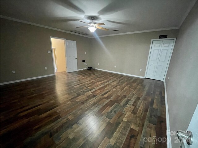 spare room with ornamental molding, dark hardwood / wood-style flooring, and ceiling fan