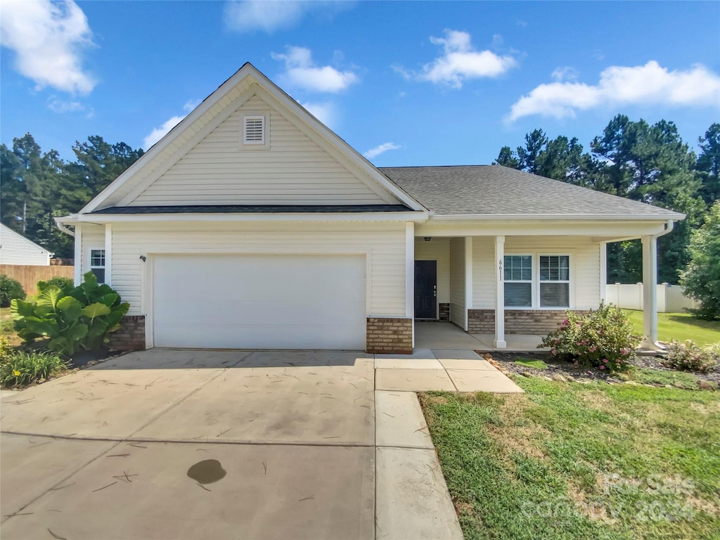 view of front of house featuring a garage and a front lawn