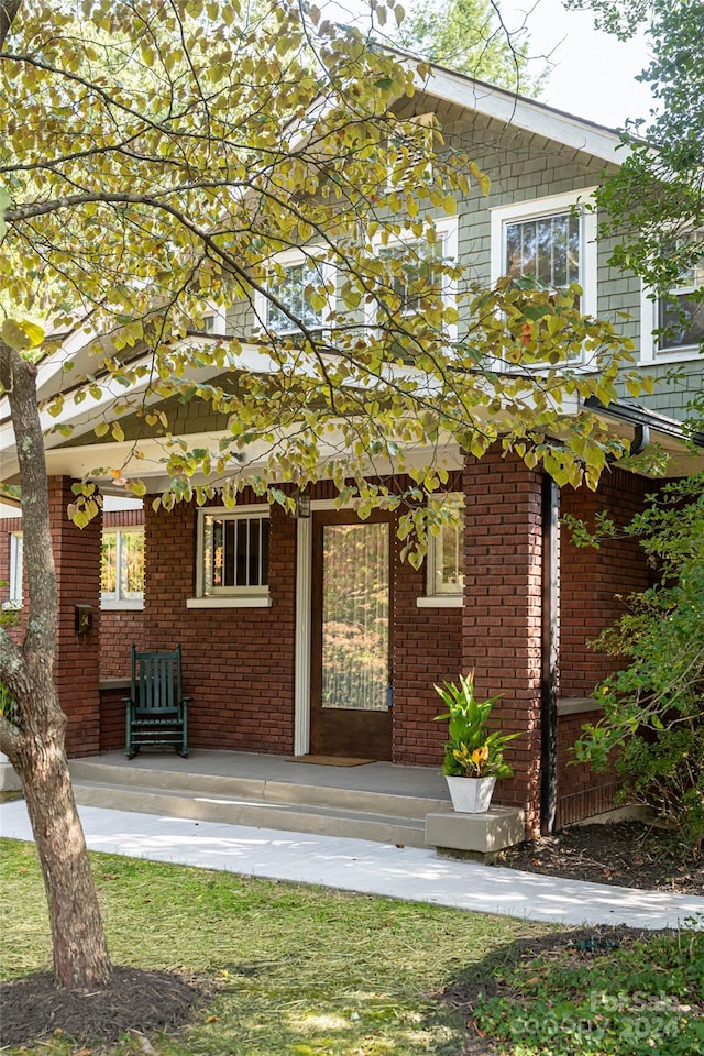 back of property with a porch