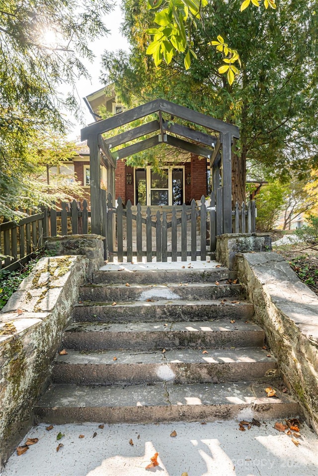 exterior space featuring fence and brick siding