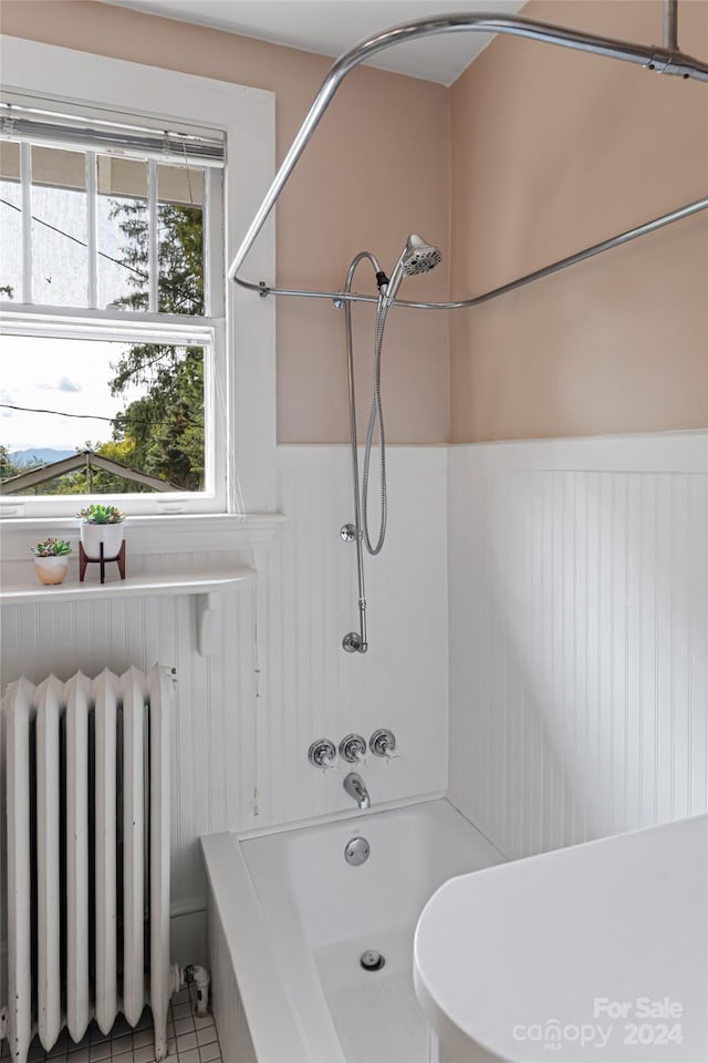 bathroom with shower / bathtub combination, toilet, radiator heating unit, and tile patterned floors