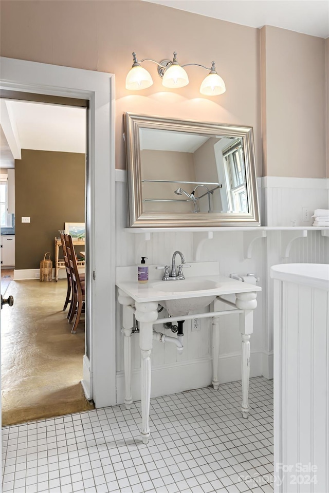 bathroom with a wainscoted wall