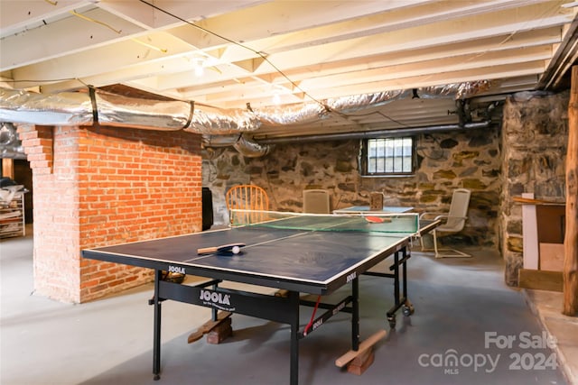 recreation room with concrete flooring