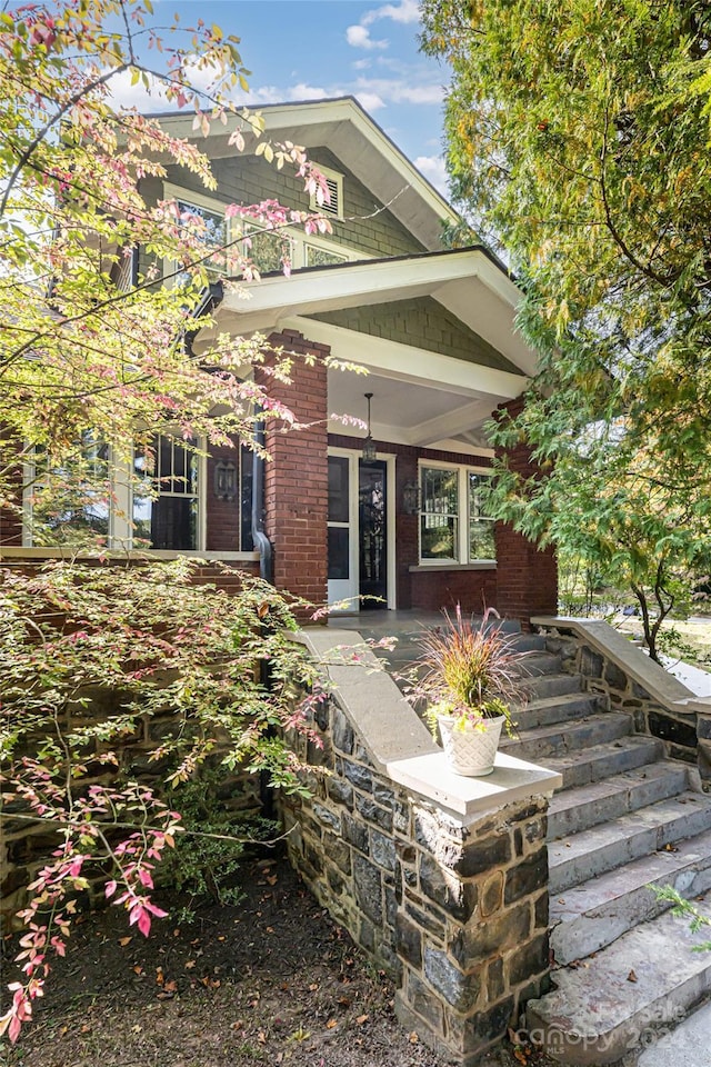 view of front of property with brick siding and a porch