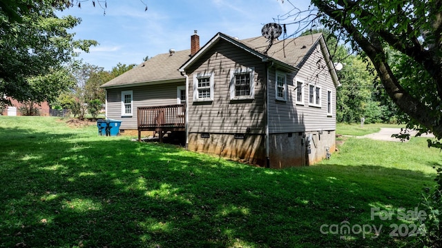 view of home's exterior with a yard and a deck