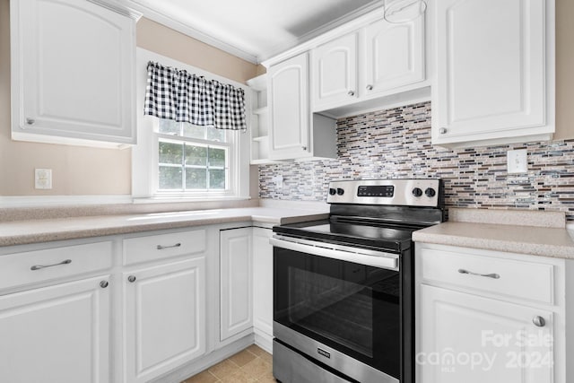 kitchen with stainless steel range with electric cooktop, light tile patterned flooring, white cabinets, and decorative backsplash