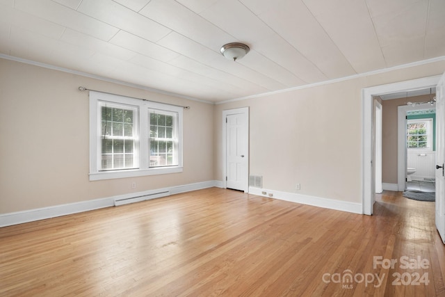 empty room with crown molding, a baseboard radiator, and light hardwood / wood-style floors