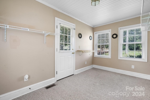 interior space featuring carpet, wooden ceiling, and ornamental molding