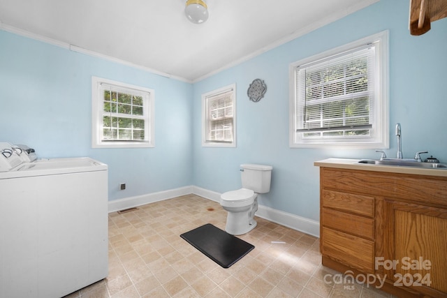 bathroom with ornamental molding, vanity, toilet, and washer and dryer