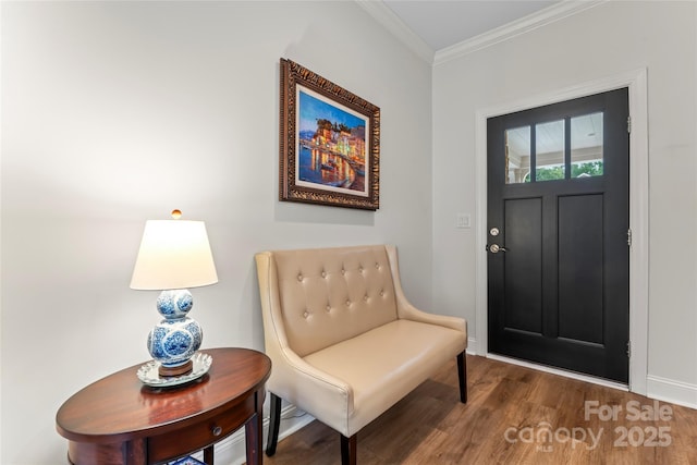 entryway with hardwood / wood-style flooring and crown molding