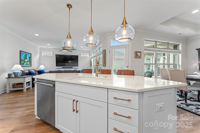 kitchen with white cabinetry, decorative light fixtures, dishwasher, an island with sink, and light stone countertops