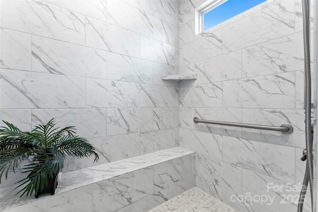 bathroom featuring tiled shower