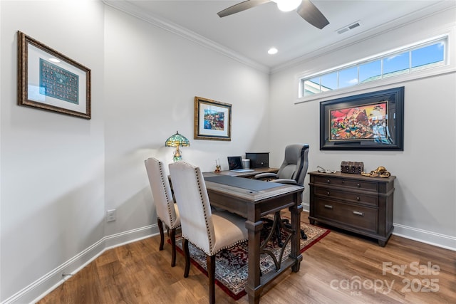 home office with crown molding, ceiling fan, and hardwood / wood-style floors