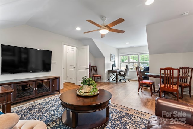 living room with wood-type flooring, lofted ceiling, and ceiling fan