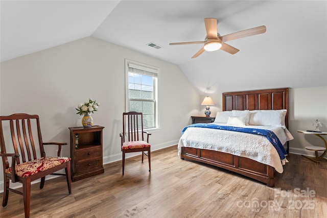 bedroom with vaulted ceiling, light hardwood / wood-style floors, and ceiling fan