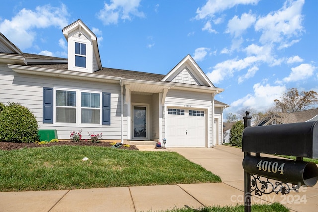 view of front of home featuring a front yard and a garage