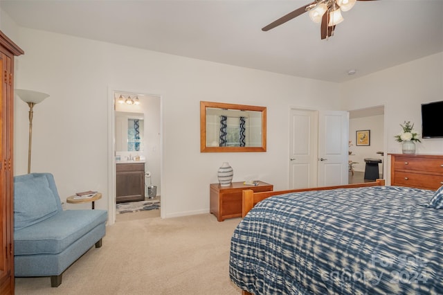 carpeted bedroom featuring ensuite bath and ceiling fan