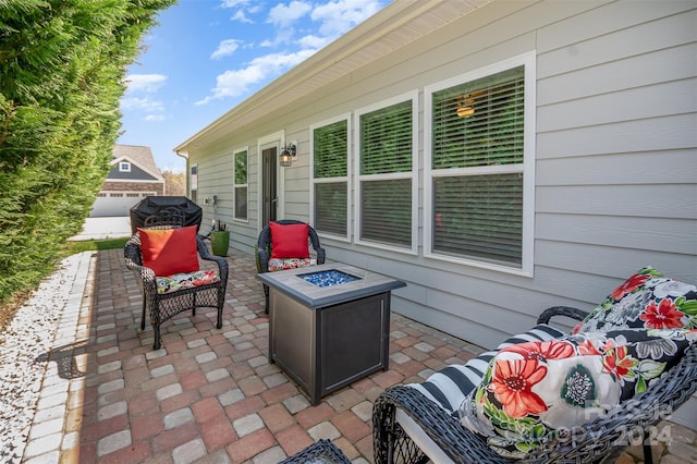 view of patio featuring an outdoor living space with a fire pit