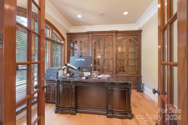 office space featuring light wood-type flooring and crown molding