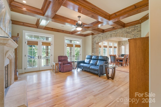 living room featuring french doors, light wood-type flooring, ceiling fan, and a wealth of natural light