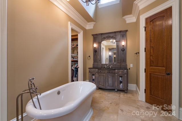 bathroom featuring vanity, a washtub, and crown molding