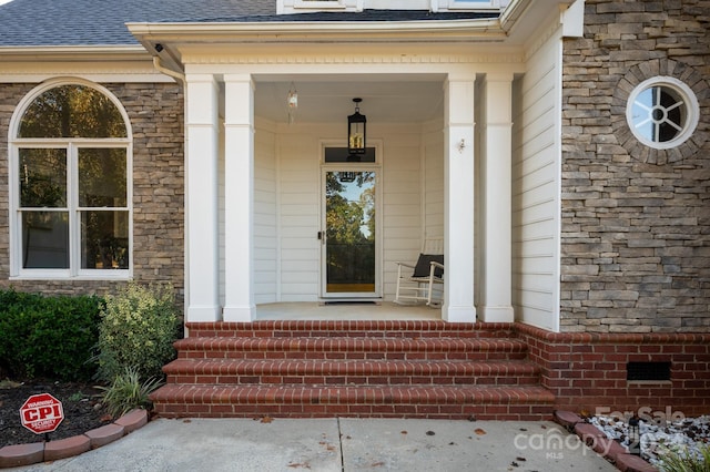 view of exterior entry with a porch