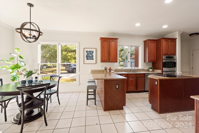 kitchen featuring appliances with stainless steel finishes, sink, a center island, and a healthy amount of sunlight