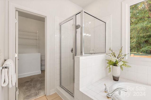 bathroom featuring tile patterned floors and plus walk in shower